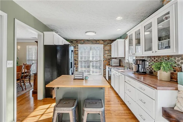 a kitchen with stainless steel appliances a refrigerator and a stove top oven