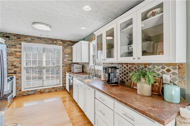a kitchen with stainless steel appliances granite countertop a refrigerator stove and sink
