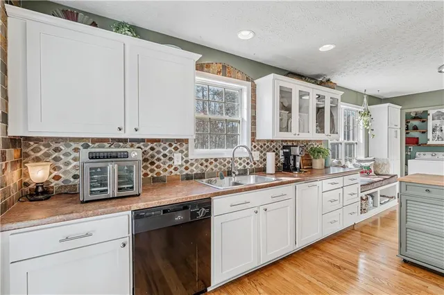 a dining room with furniture window and wooden floor