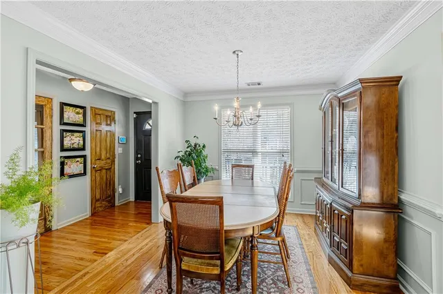 a view of a hallway with wooden floor and glass door