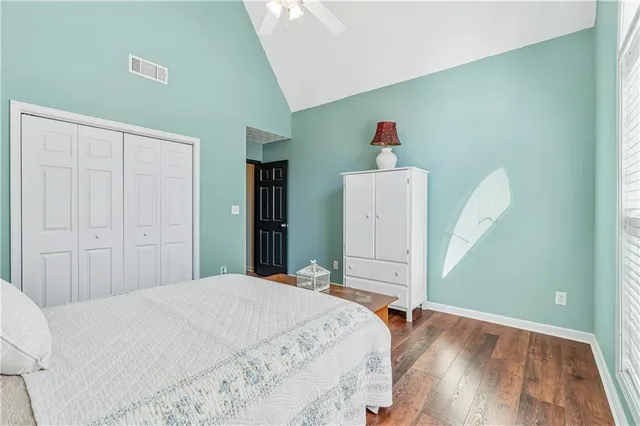 a view of a patio with a table and chairs under an umbrella with a small yard