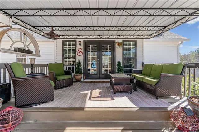 a view of a patio with table and chairs and potted plants