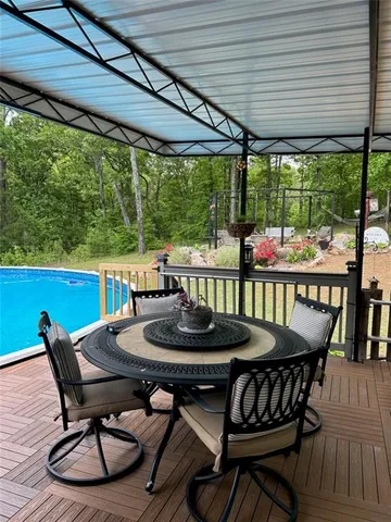 a view of a patio with table and chairs under an umbrella
