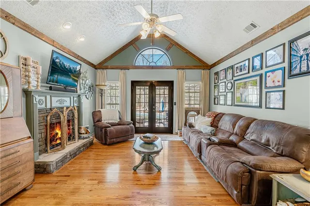 a living room with furniture and a chandelier