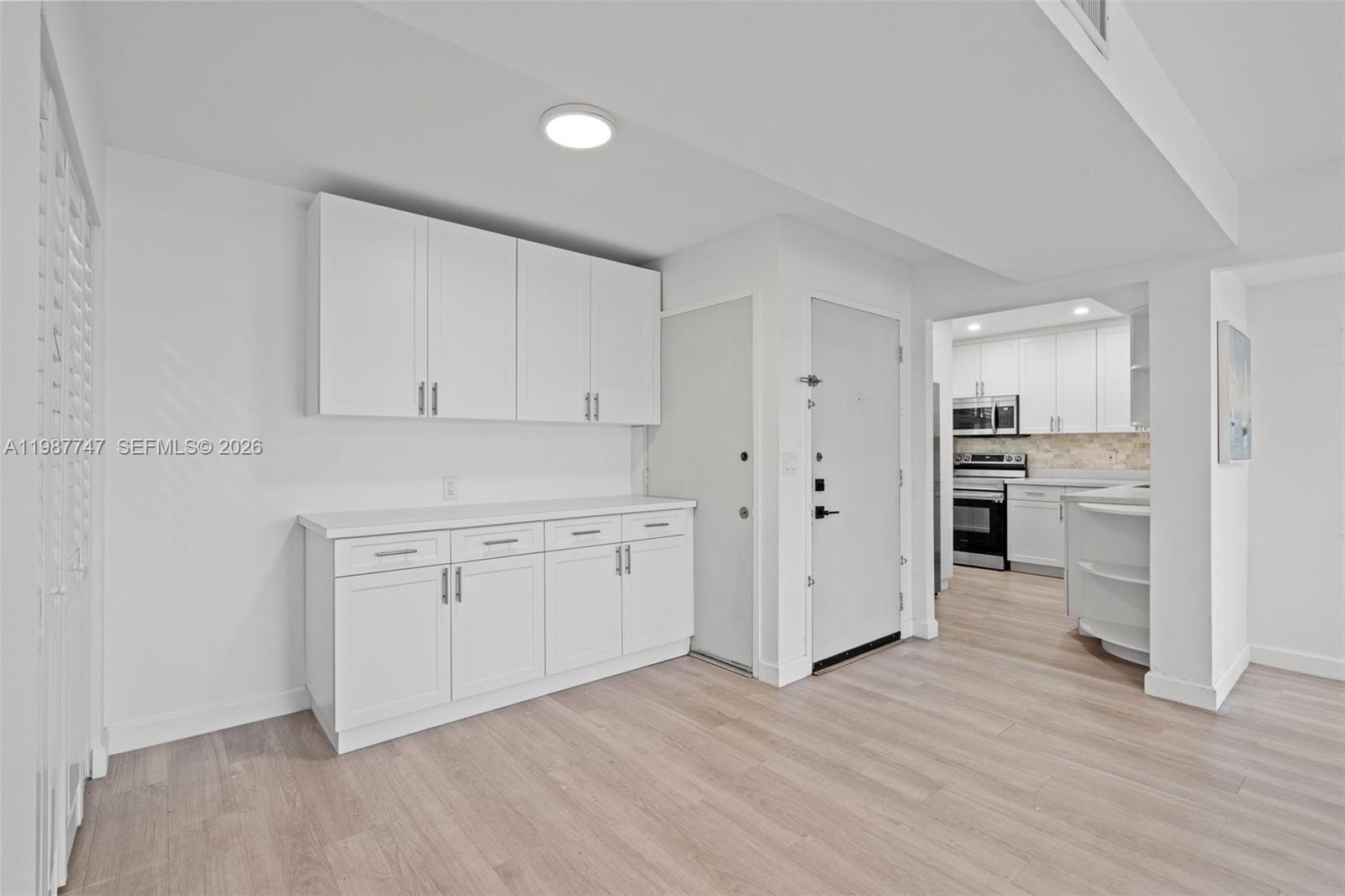 7765 Southwest 86th Street, Unit F2303 Miami, FL 33143 - Photo 11 of 50 a view of a kitchen with wooden floor