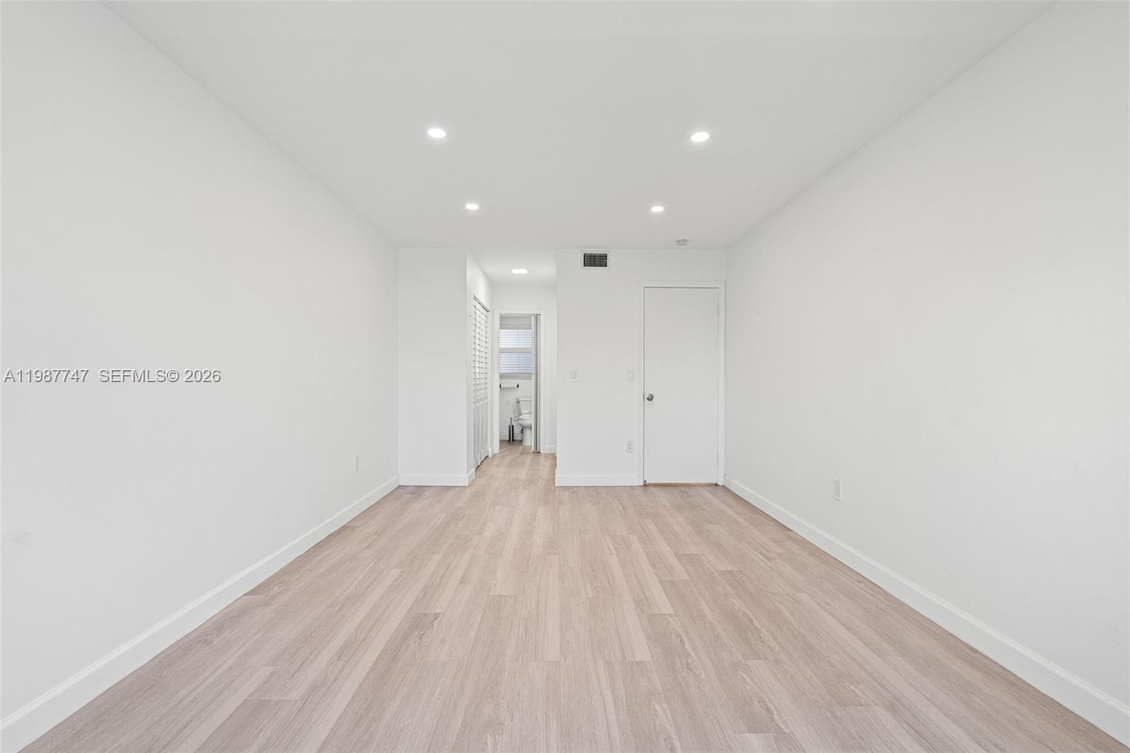 7765 Southwest 86th Street, Unit F2303 Miami, FL 33143 - Photo 18 of 50 a view of empty room with wooden floor