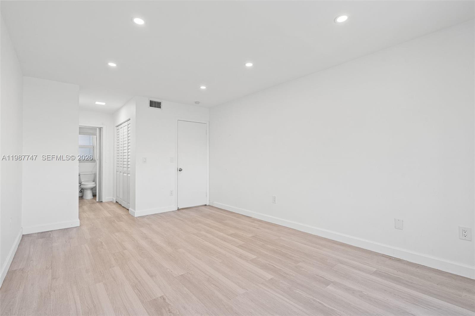 7765 Southwest 86th Street, Unit F2303 Miami, FL 33143 - Photo 19 of 50 a view of an empty room with wooden floor