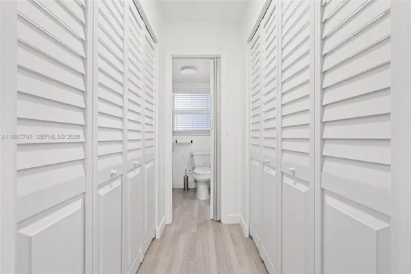 a view of walk in closet with empty racks