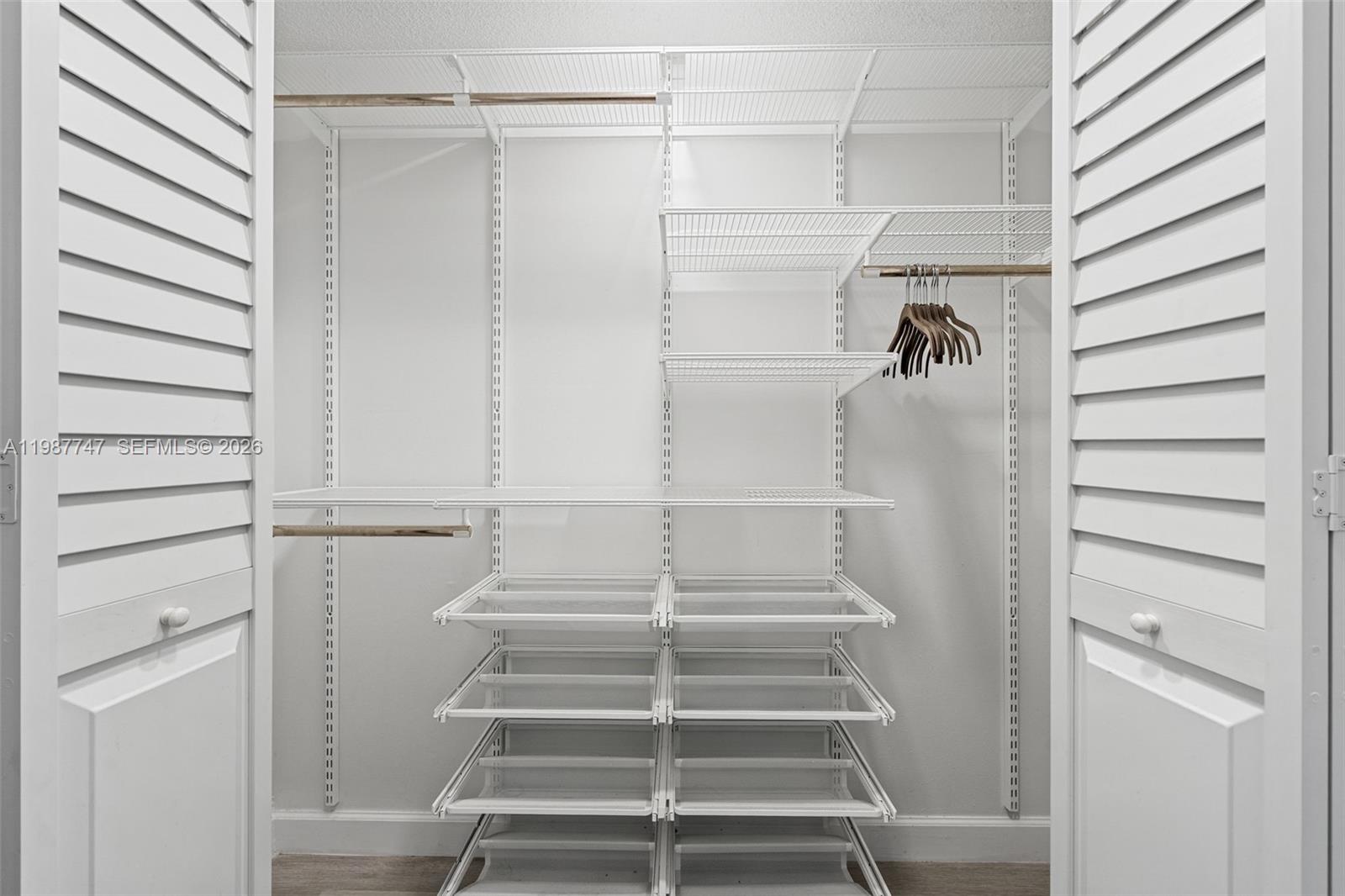 7765 Southwest 86th Street, Unit F2303 Miami, FL 33143 - Photo 21 of 50 a view of walk in closet with empty racks