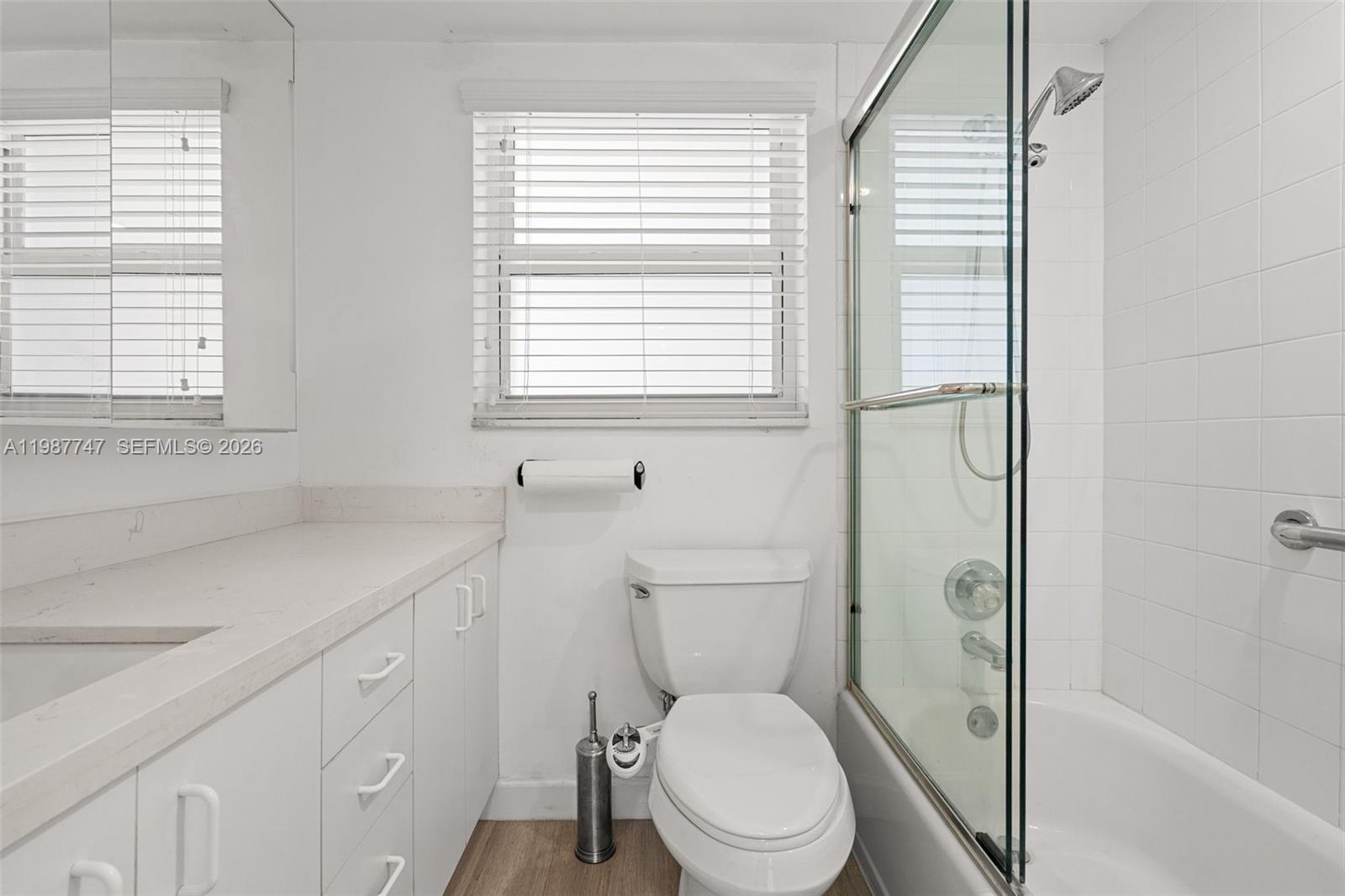 7765 Southwest 86th Street, Unit F2303 Miami, FL 33143 - Photo 24 of 50 a bathroom with a toilet a sink and a bathtub