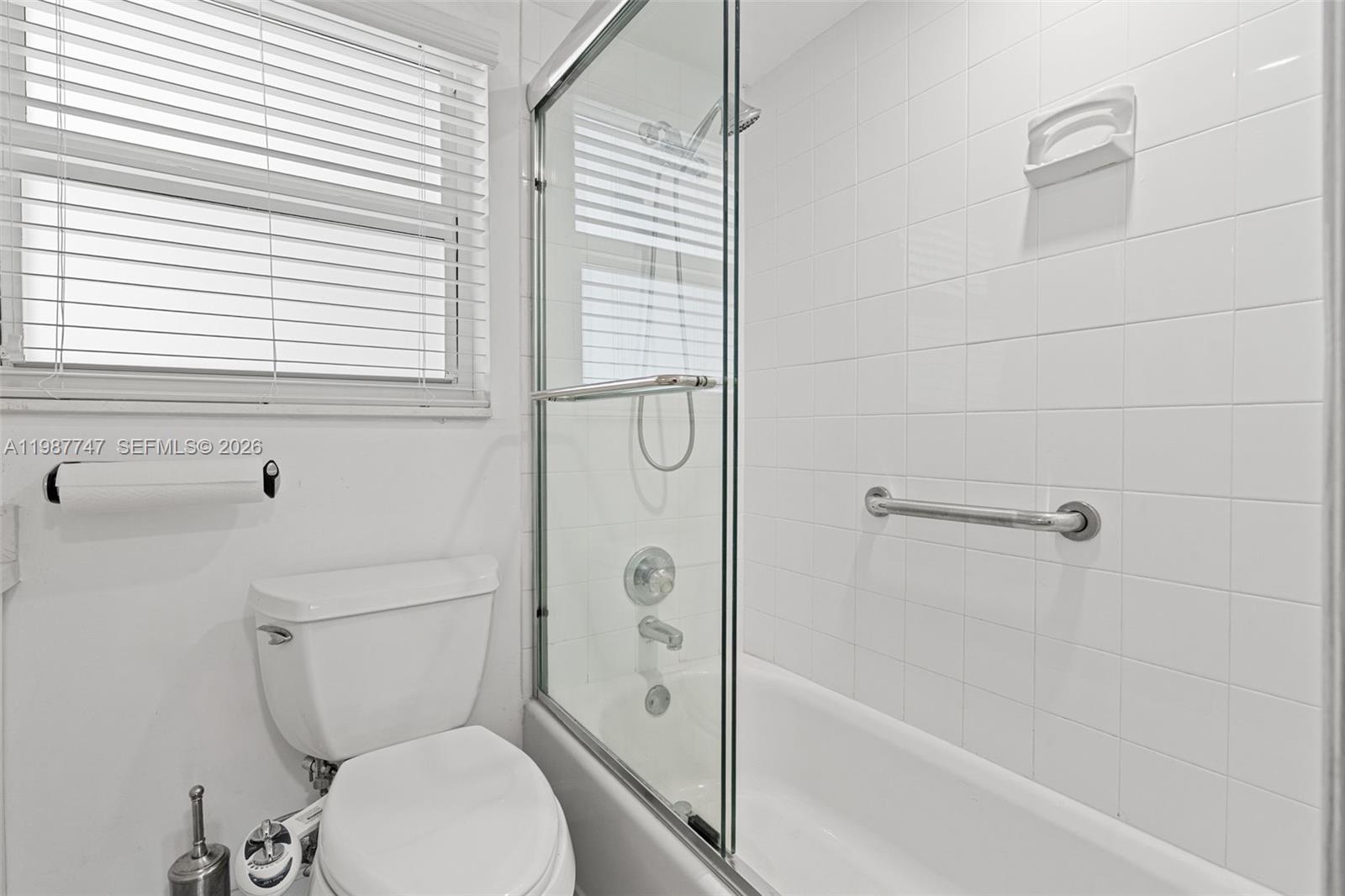 7765 Southwest 86th Street, Unit F2303 Miami, FL 33143 - Photo 25 of 50 a bathroom with a toilet and a shower