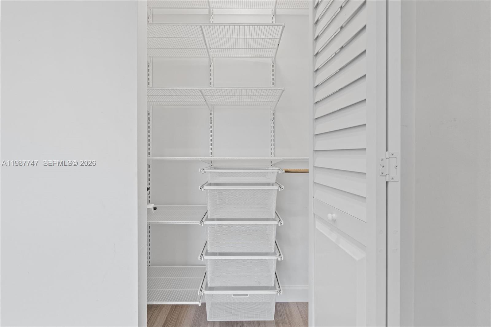 7765 Southwest 86th Street, Unit F2303 Miami, FL 33143 - Photo 29 of 50 a view of walk in closet with empty racks