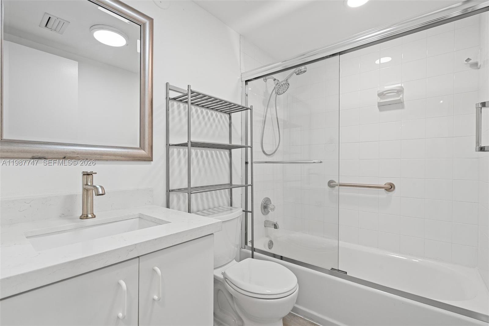 7765 Southwest 86th Street, Unit F2303 Miami, FL 33143 - Photo 30 of 50 a bathroom with a sink a toilet and shower