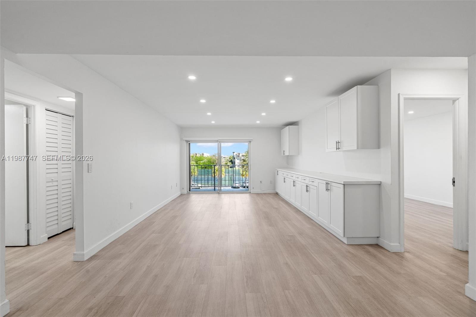 7765 Southwest 86th Street, Unit F2303 Miami, FL 33143 - Photo 3 of 50 a view of a hallway with wooden floor and staircase