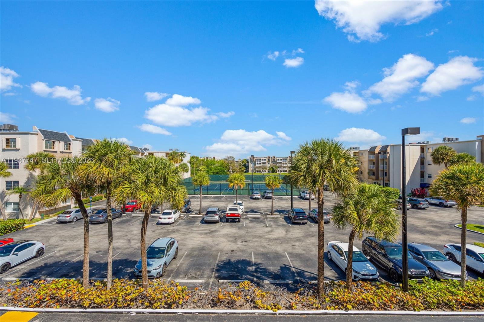 7765 Southwest 86th Street, Unit F2303 Miami, FL 33143 - Photo 31 of 50 a view of a yard with cars parked