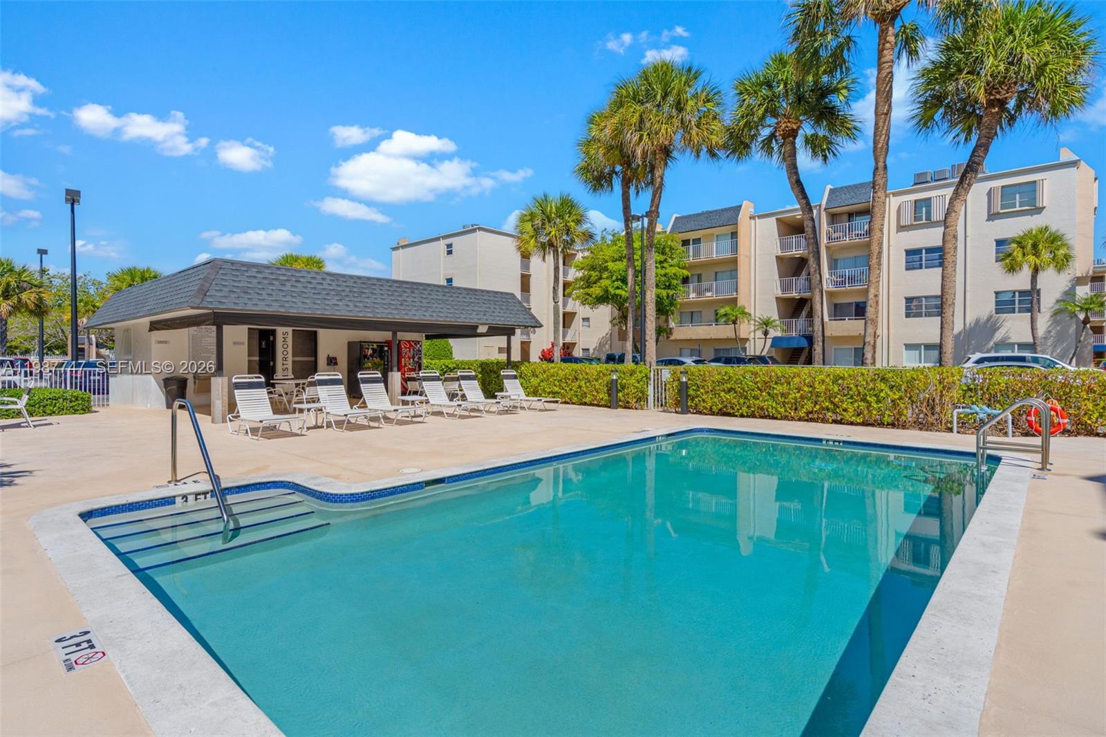 7765 Southwest 86th Street, Unit F2303 Miami, FL 33143 - Photo 37 of 50 a swimming pool view with a seating space and a garden view