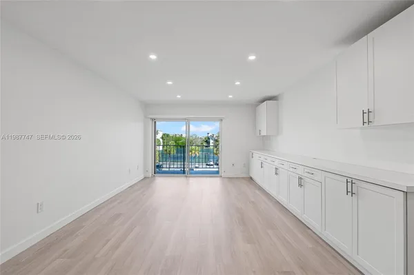 a view of a kitchen with white cabinets