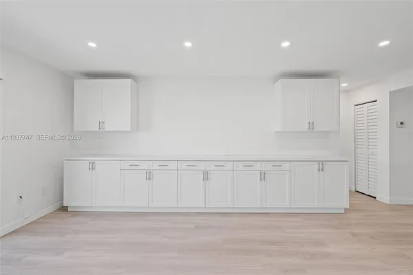 a view of a kitchen with wooden floor