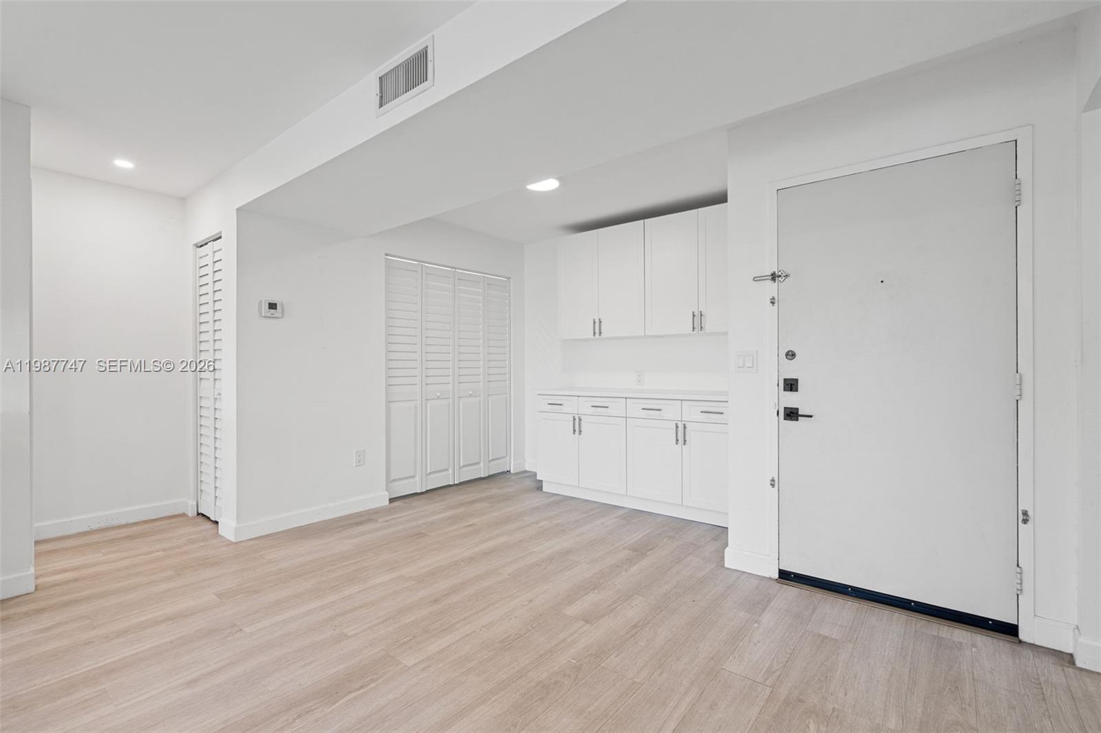 7765 Southwest 86th Street, Unit F2303 Miami, FL 33143 - Photo 10 of 50 a view of an empty room with wooden floor