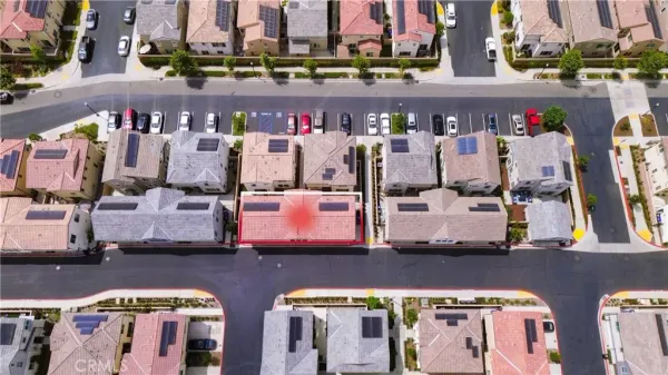 an aerial view of multiple houses with yard