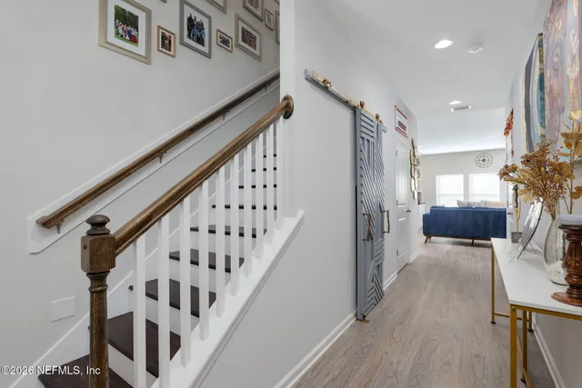 a view of entryway and hall with wooden floor