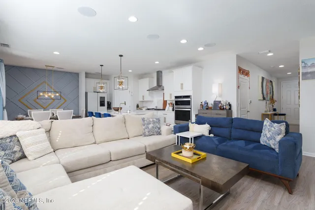 a picture of a room with a white wall and a refrigerator