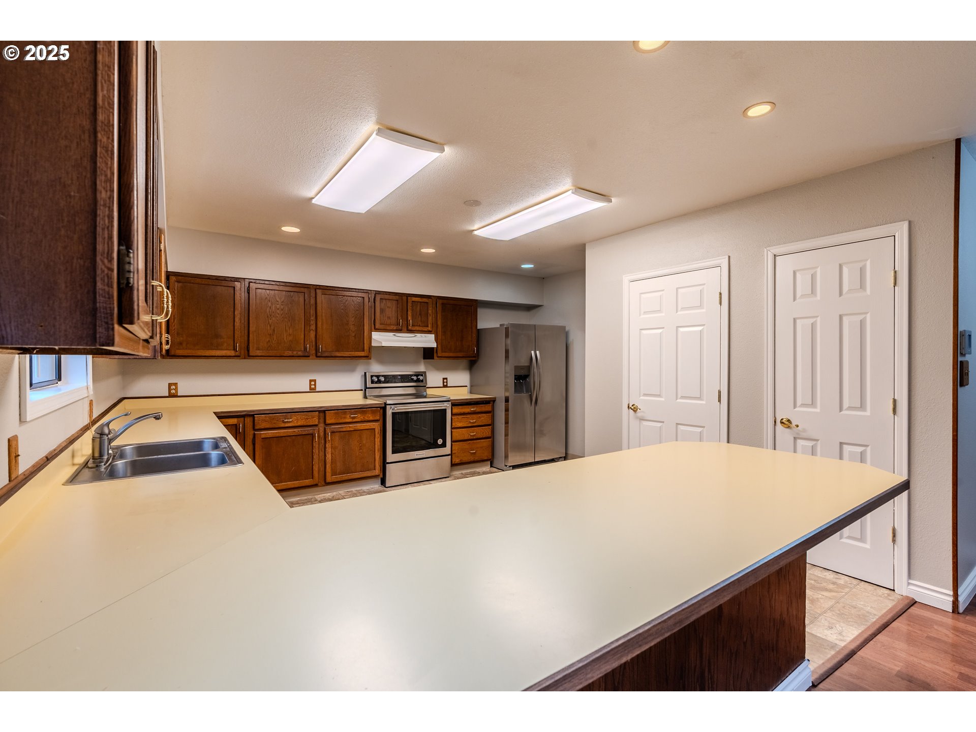 35709 Southeast Lusted Road Boring, OR 97009 - Photo 13 of 48 a kitchen with stainless steel appliances a sink a stove a microwave a counter top space and cabinets