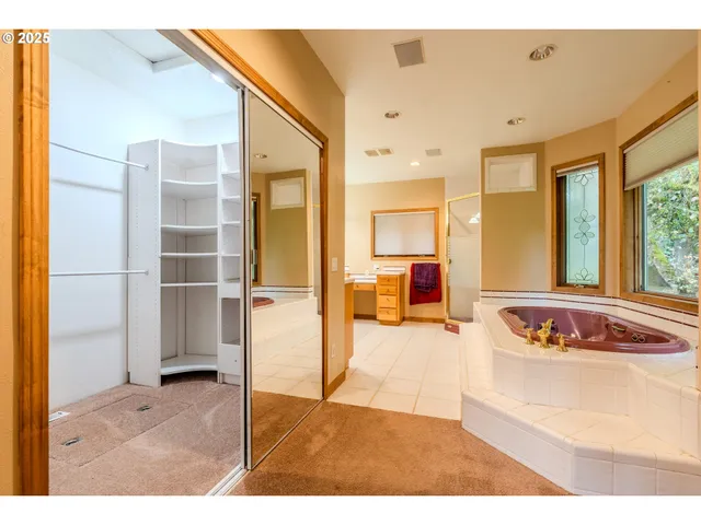 a bedroom with furniture and a large window