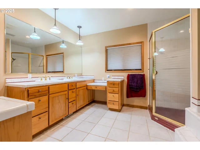 a spacious bathroom with a sink a mirror and a bathtub
