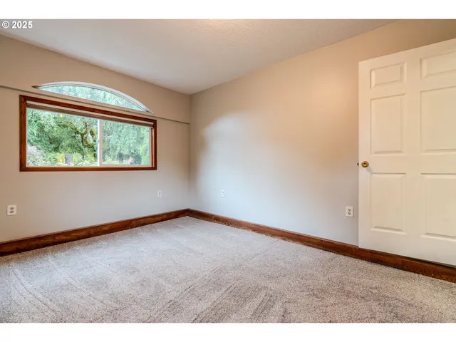 a view of a livingroom with wooden floor and entryway
