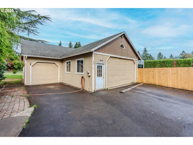 a view of a barn in the middle of a big yard