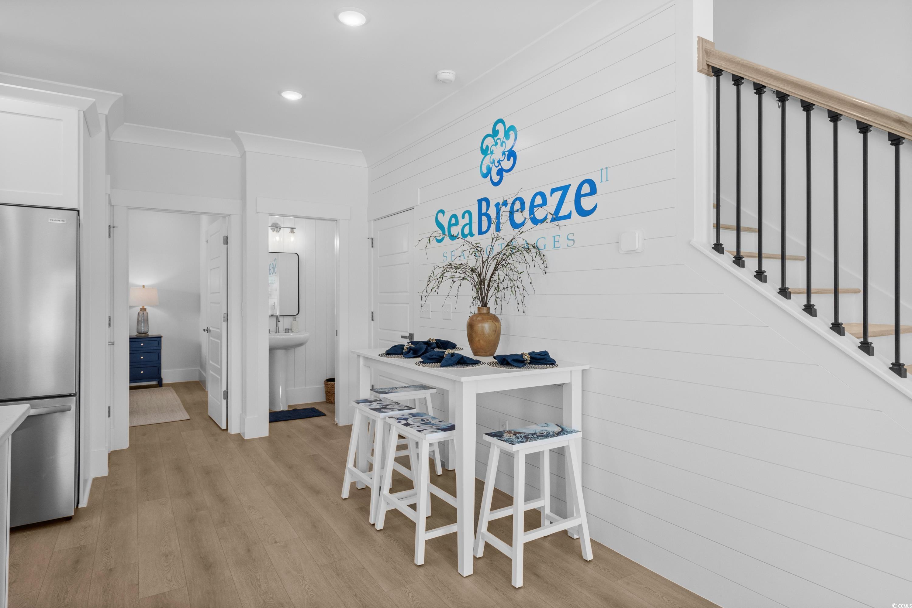 2303 Seaseeker Lane Myrtle Beach, SC 29577 - Photo 14 of 38 Dining area with wood finished floors, stairs, recessed lighting, and wooden walls