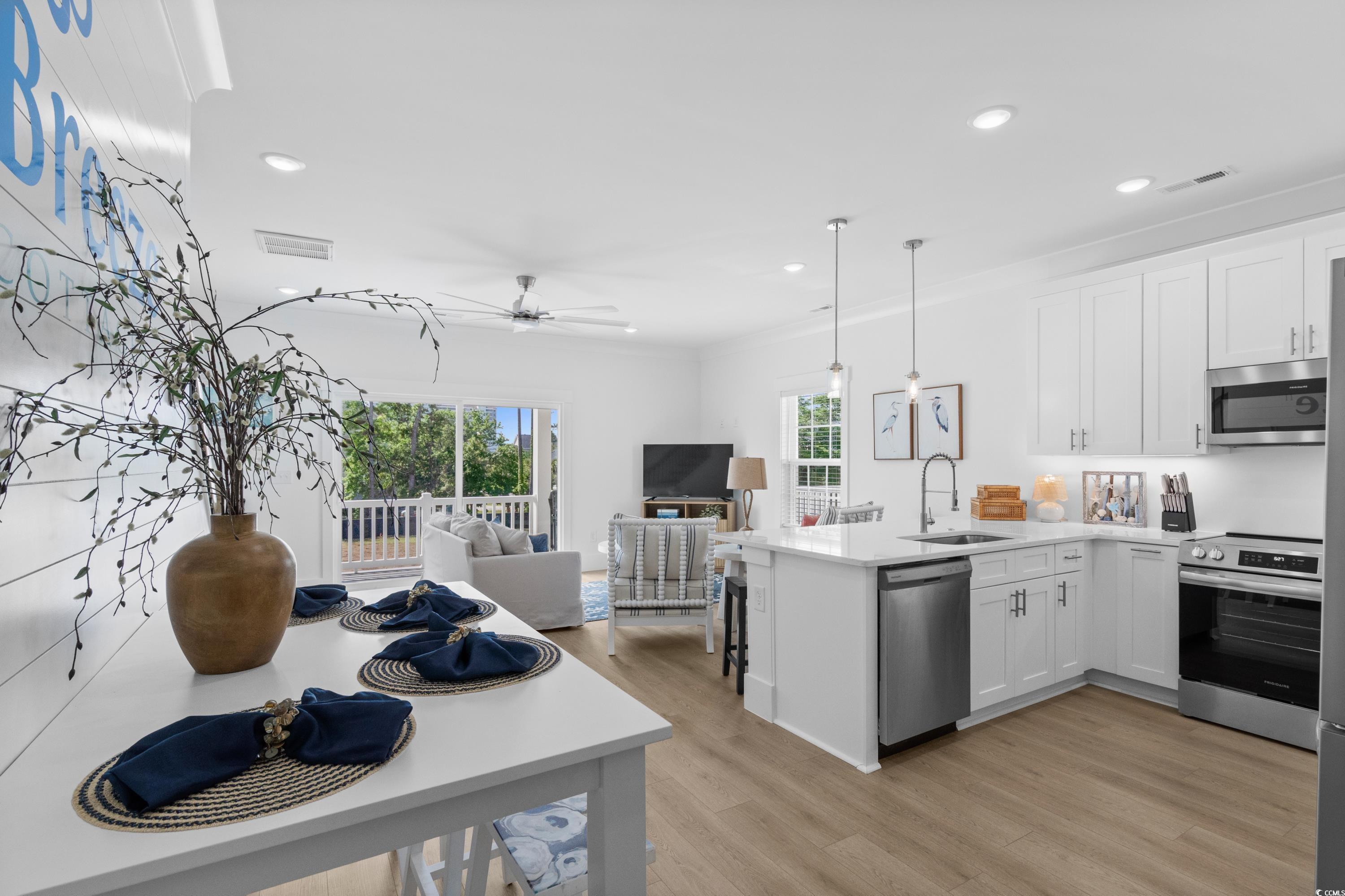 2303 Seaseeker Lane Myrtle Beach, SC 29577 - Photo 19 of 38 Living area with healthy amount of natural light, light wood finished floors, recessed lighting, and baseboards