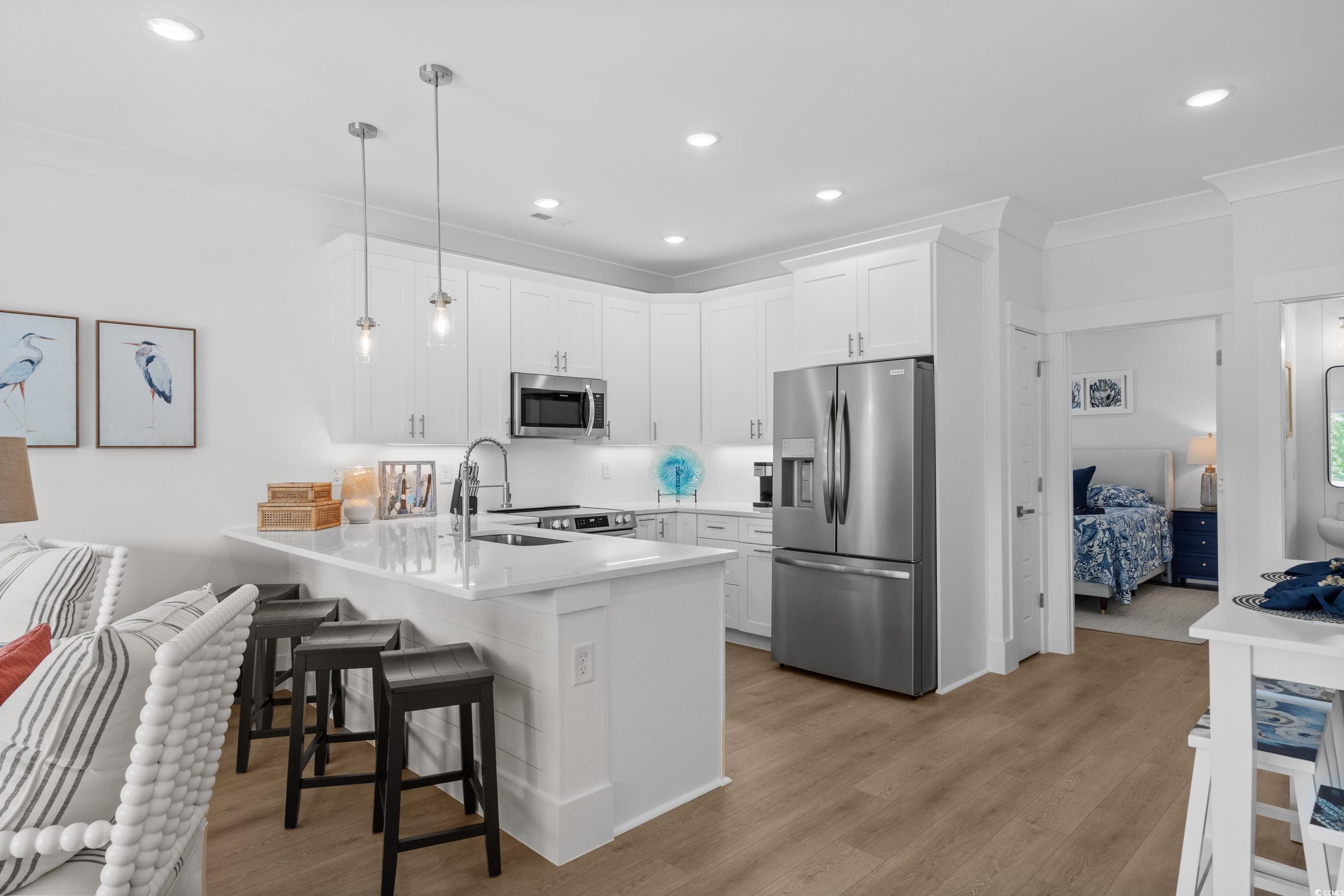 2303 Seaseeker Lane Myrtle Beach, SC 29577 - Photo 20 of 38 Living area with a ceiling fan, light wood-style flooring, recessed lighting, stairway, and ornamental molding