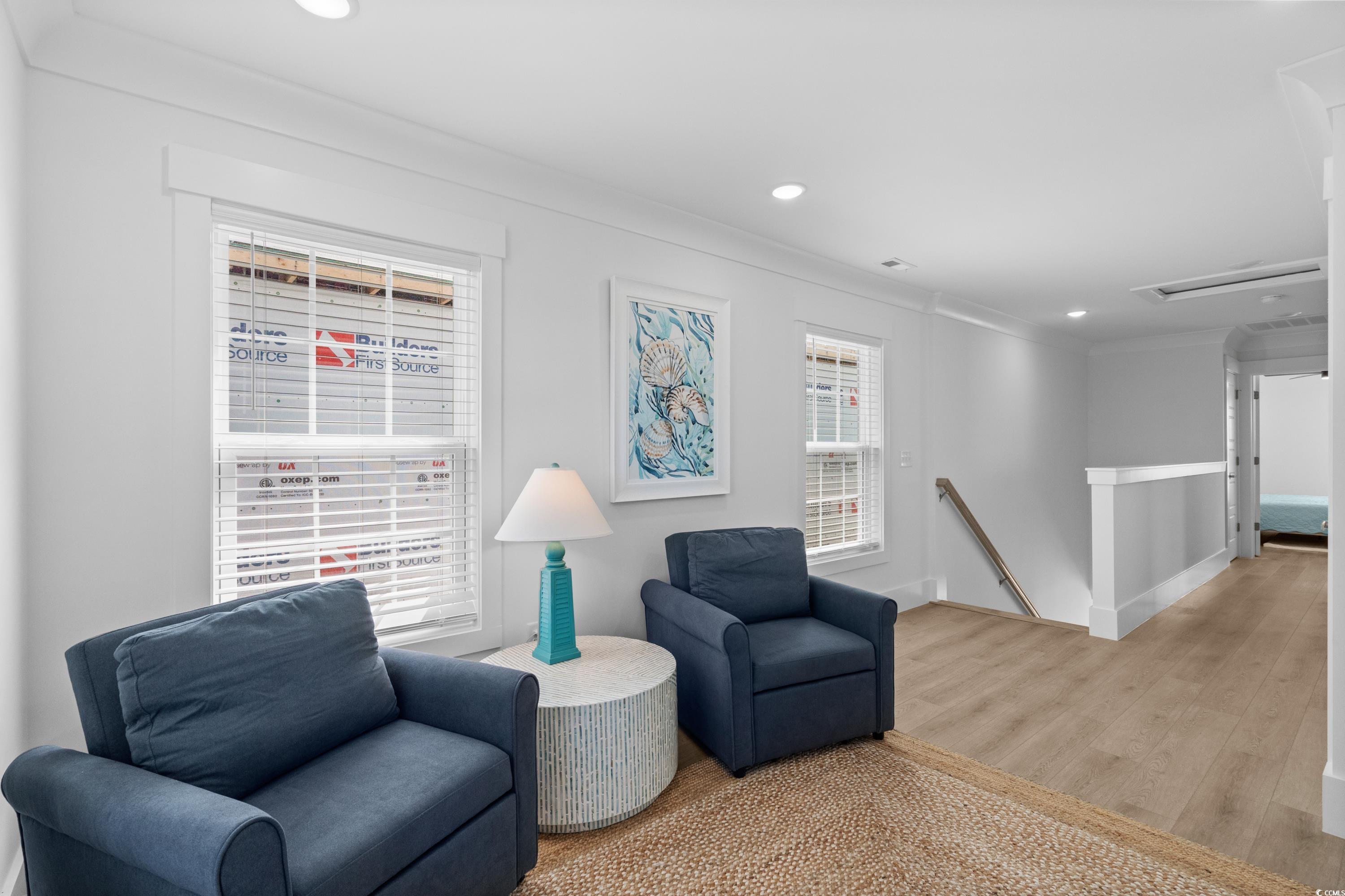 2303 Seaseeker Lane Myrtle Beach, SC 29577 - Photo 27 of 38 Living area with crown molding, wood finished floors, baseboards, ceiling fan, and recessed lighting