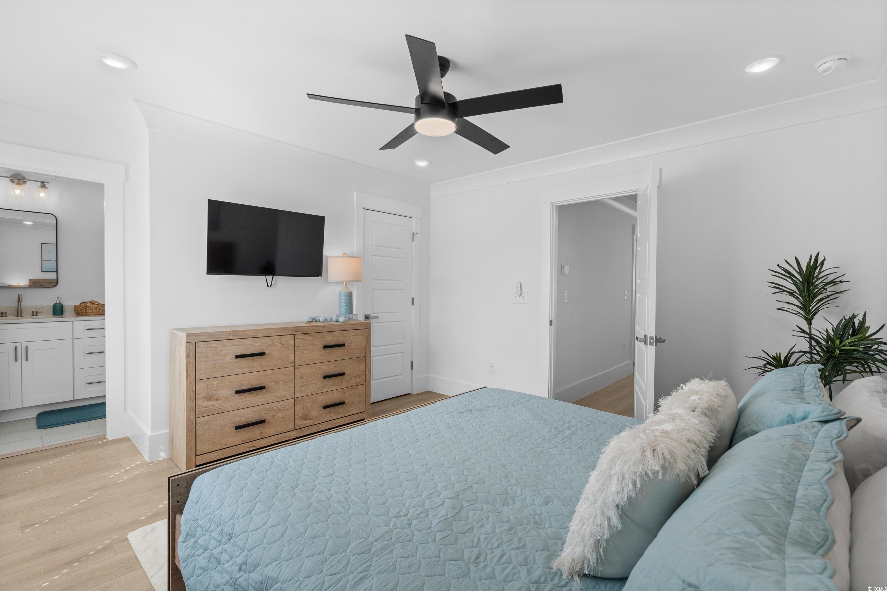 2303 Seaseeker Lane Myrtle Beach, SC 29577 - Photo 34 of 38 Bedroom featuring light wood finished floors, a closet, baseboards, a ceiling fan, and connected bathroom
