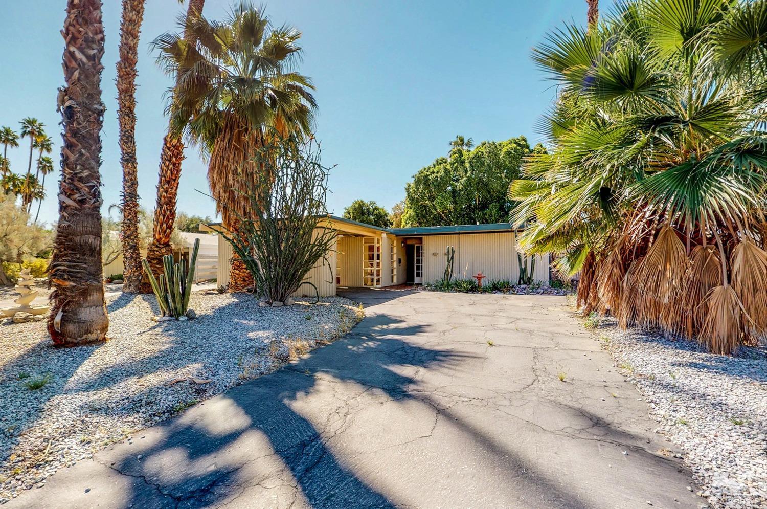 71906 Vista Del Rio Rancho Mirage, CA 92270 - Photo 2 of 27 a view of a house with a yard and garage