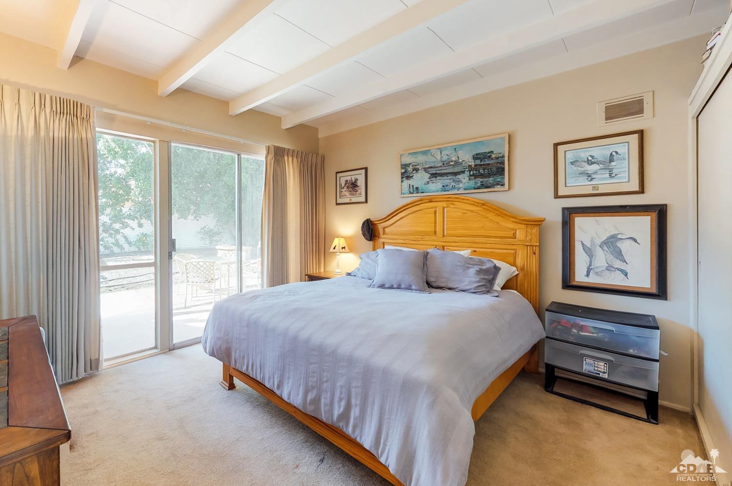 71906 Vista Del Rio Rancho Mirage, CA 92270 - Photo 17 of 27 a bedroom with a bed and a painting on the wall