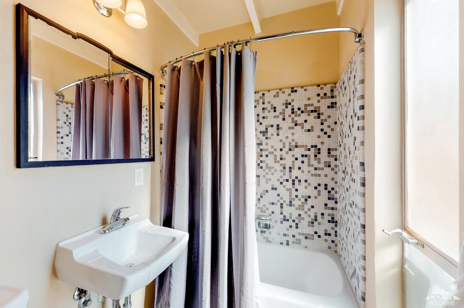 71906 Vista Del Rio Rancho Mirage, CA 92270 - Photo 18 of 27 a bathroom with a shower a mirror and a sink