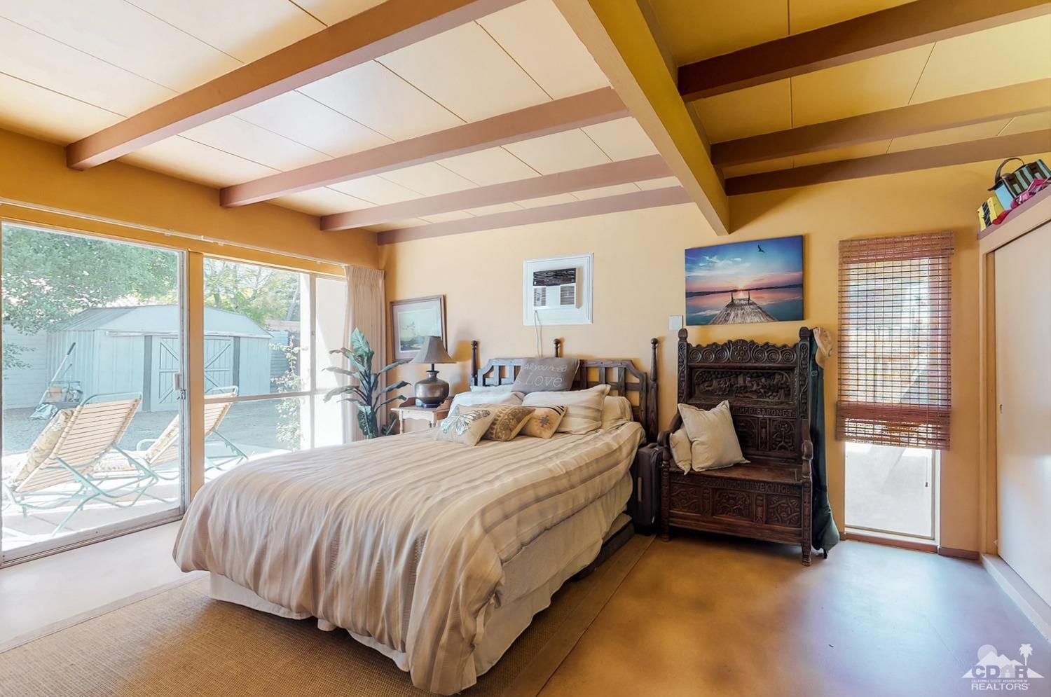 71906 Vista Del Rio Rancho Mirage, CA 92270 - Photo 19 of 27 a bedroom with a bed and a large window with the outer view