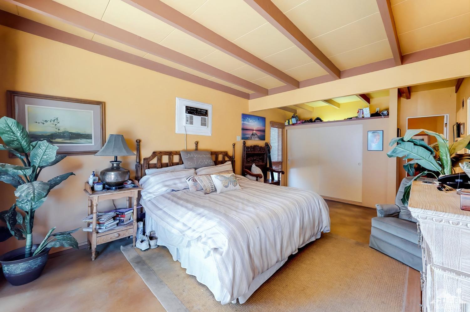 71906 Vista Del Rio Rancho Mirage, CA 92270 - Photo 21 of 27 a bedroom with bed and a potted plant