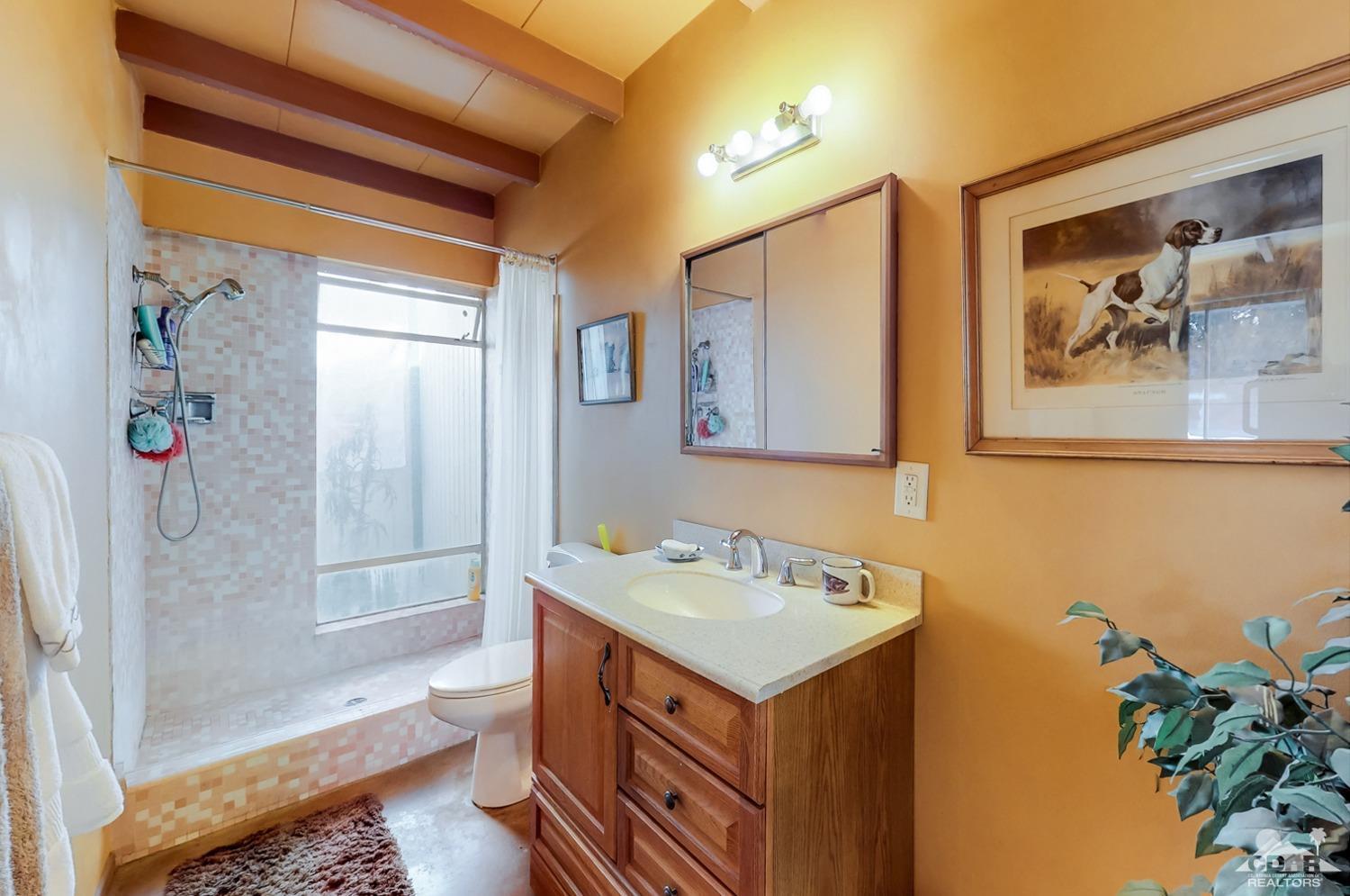 71906 Vista Del Rio Rancho Mirage, CA 92270 - Photo 22 of 27 a bathroom with a sink a vanity and a mirror