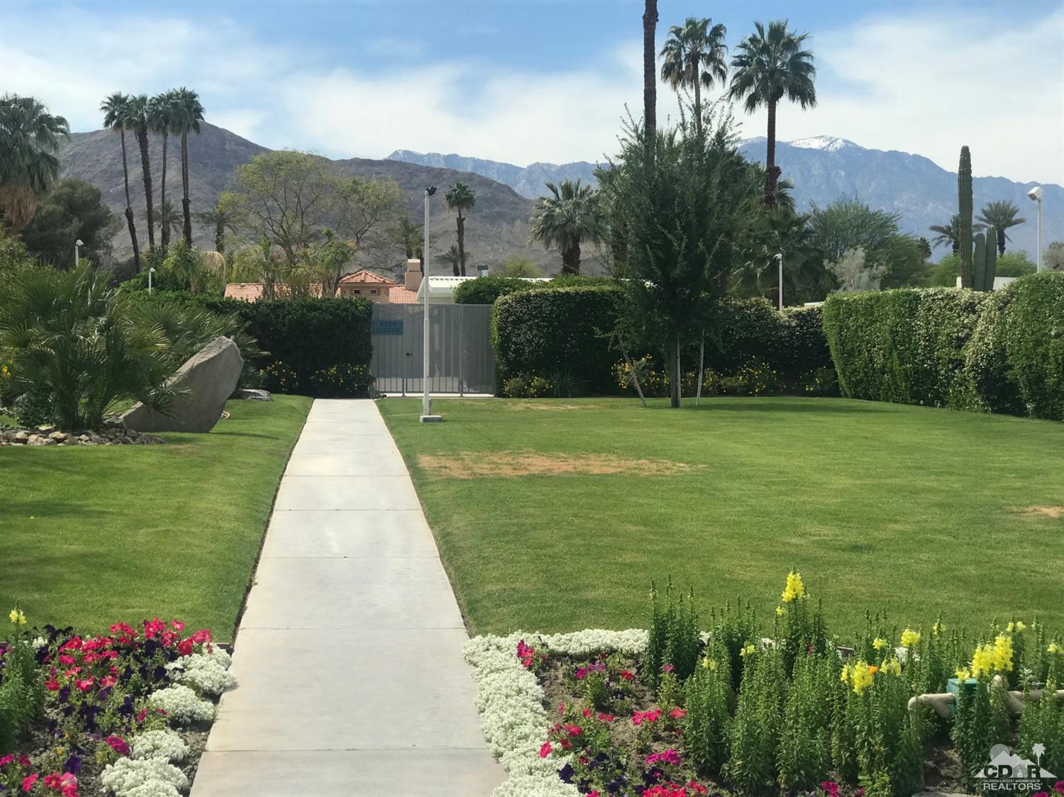71906 Vista Del Rio Rancho Mirage, CA 92270 - Photo 24 of 27 a view of a garden with a building in the background