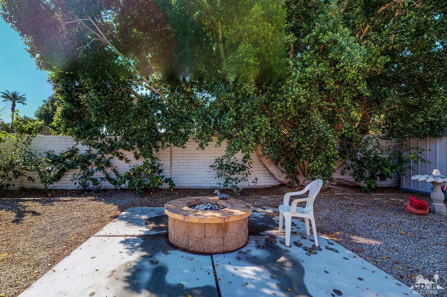 71906 Vista Del Rio Rancho Mirage, CA 92270 - Photo 7 of 27 a view of a backyard with table and chairs potted plants