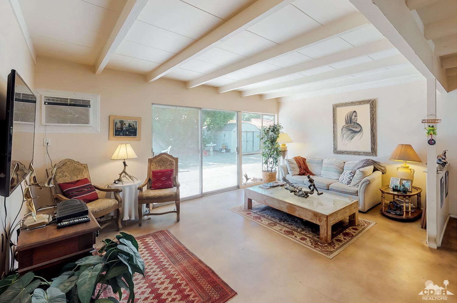 71906 Vista Del Rio Rancho Mirage, CA 92270 - Photo 9 of 27 a living room with furniture rug and wooden floor