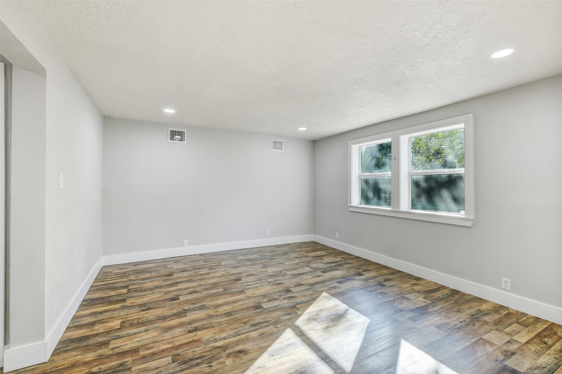 31423 Reids Prairie Road Waller, TX 77484 - Photo 16 of 49 a view of an empty room with wooden floor and a window