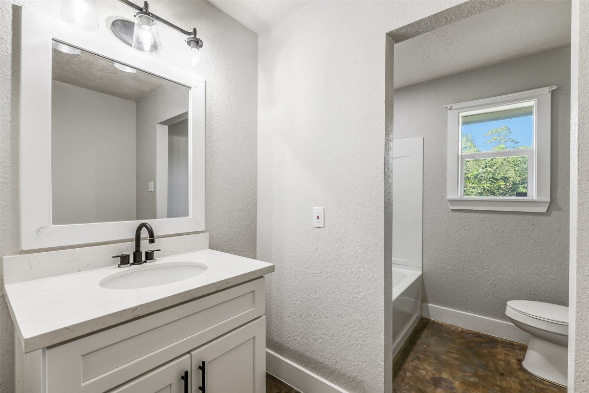 31423 Reids Prairie Road Waller, TX 77484 - Photo 28 of 49 a bathroom with a sink a light fixture and a toilet
