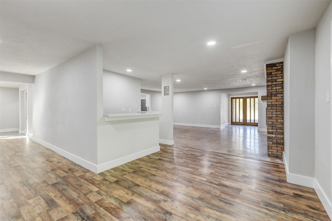 31423 Reids Prairie Road Waller, TX 77484 - Photo 8 of 49 a view of an empty room with wooden floor and a kitchen