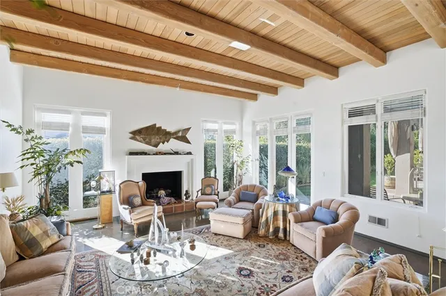 a living room with furniture fireplace and a large window