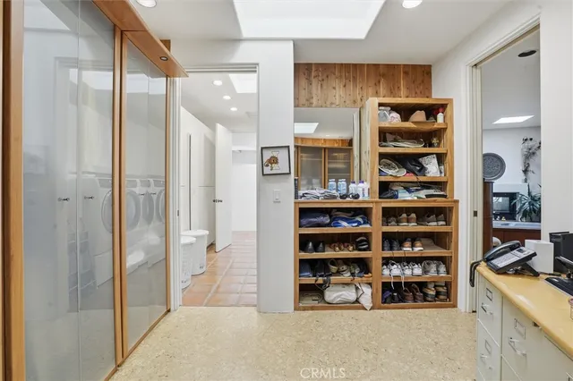 a bedroom with furniture and a large window
